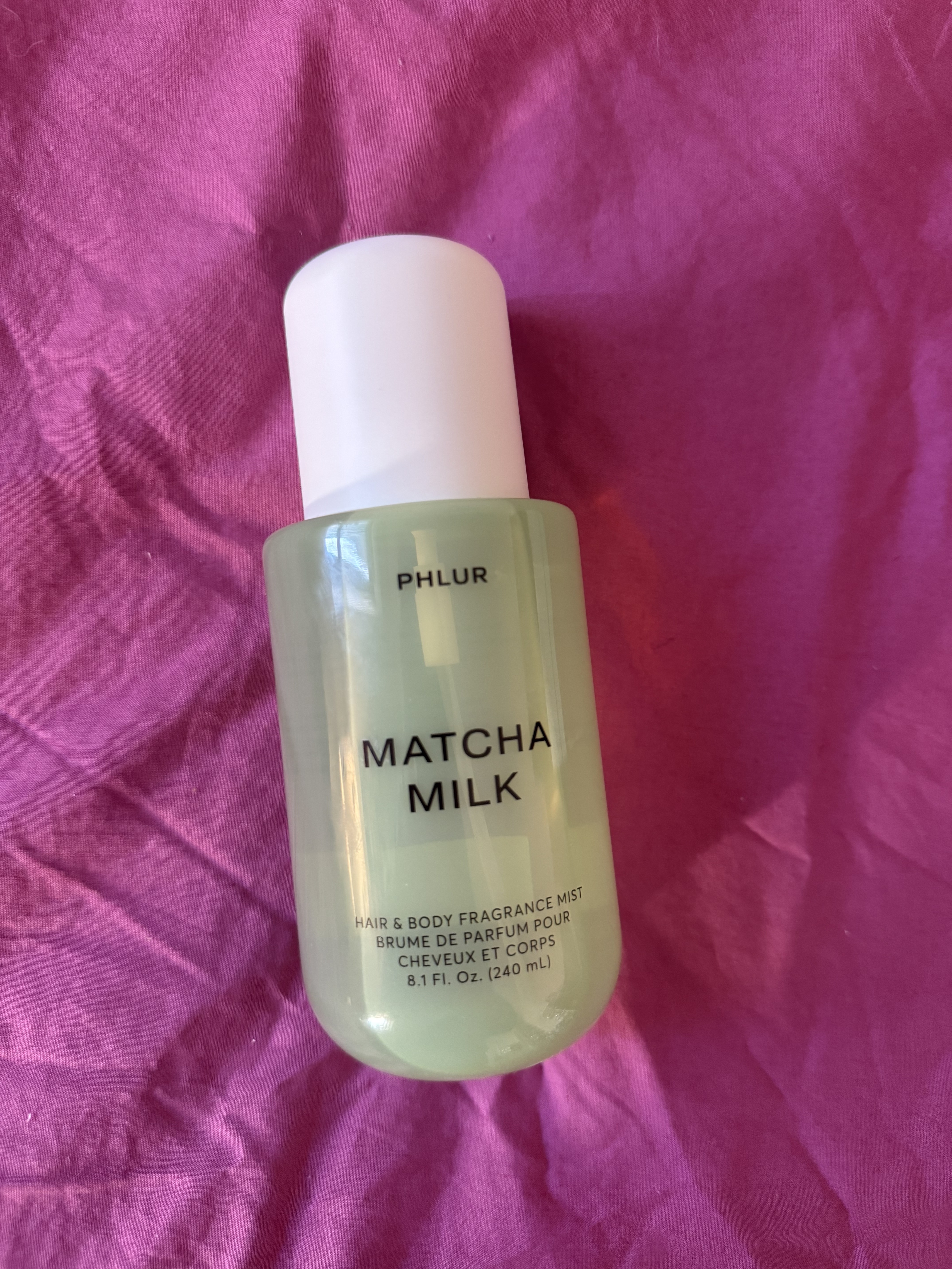 Phlur's Matcha Milk on a pink background