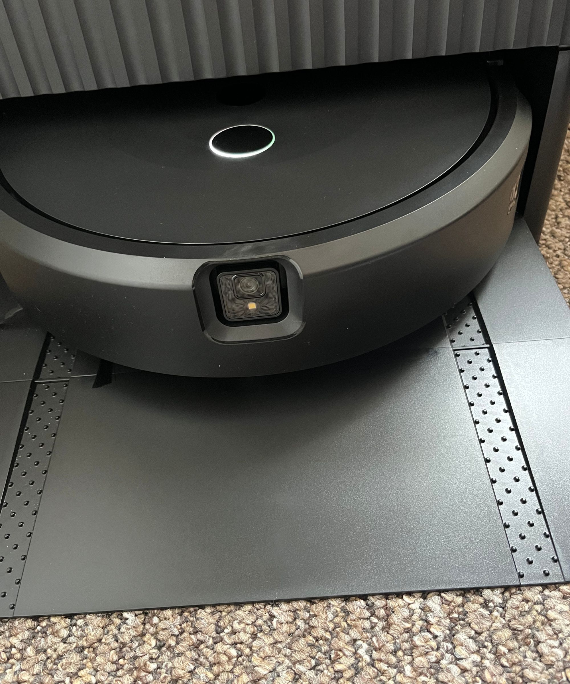 The Roomba vacuum in the dock