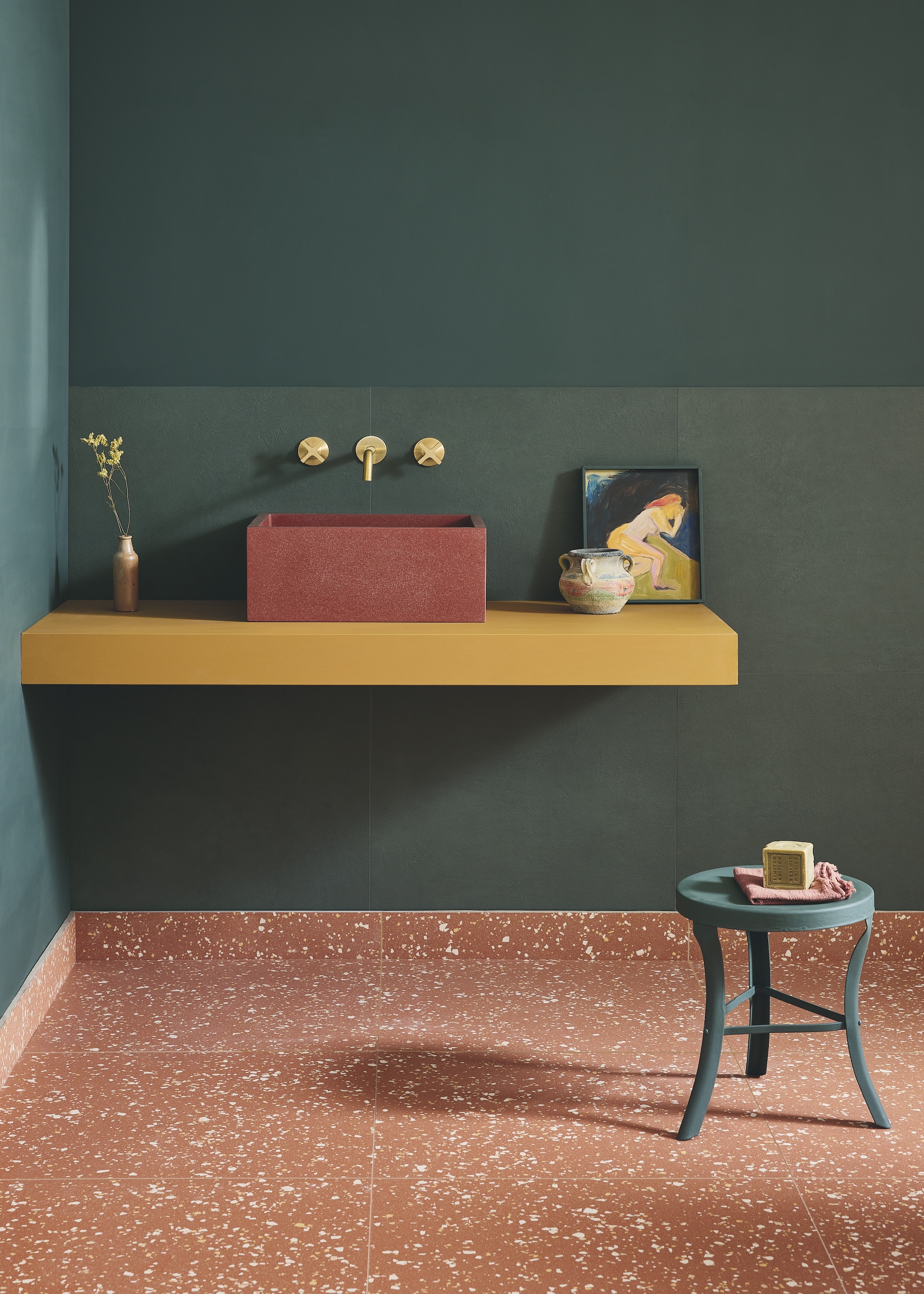 a green walled bathroom with a terracotta terrazzo floor