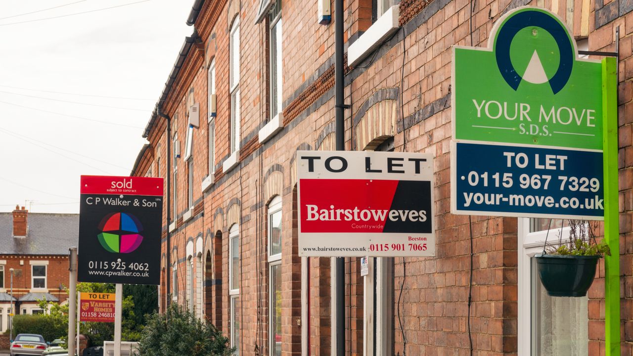 for sale signs on rows of terraces