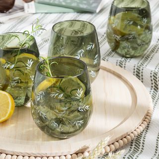 green tumblers on a tray on a picnic blanket, included in Stacey Solomon's George Home outdoor collection
