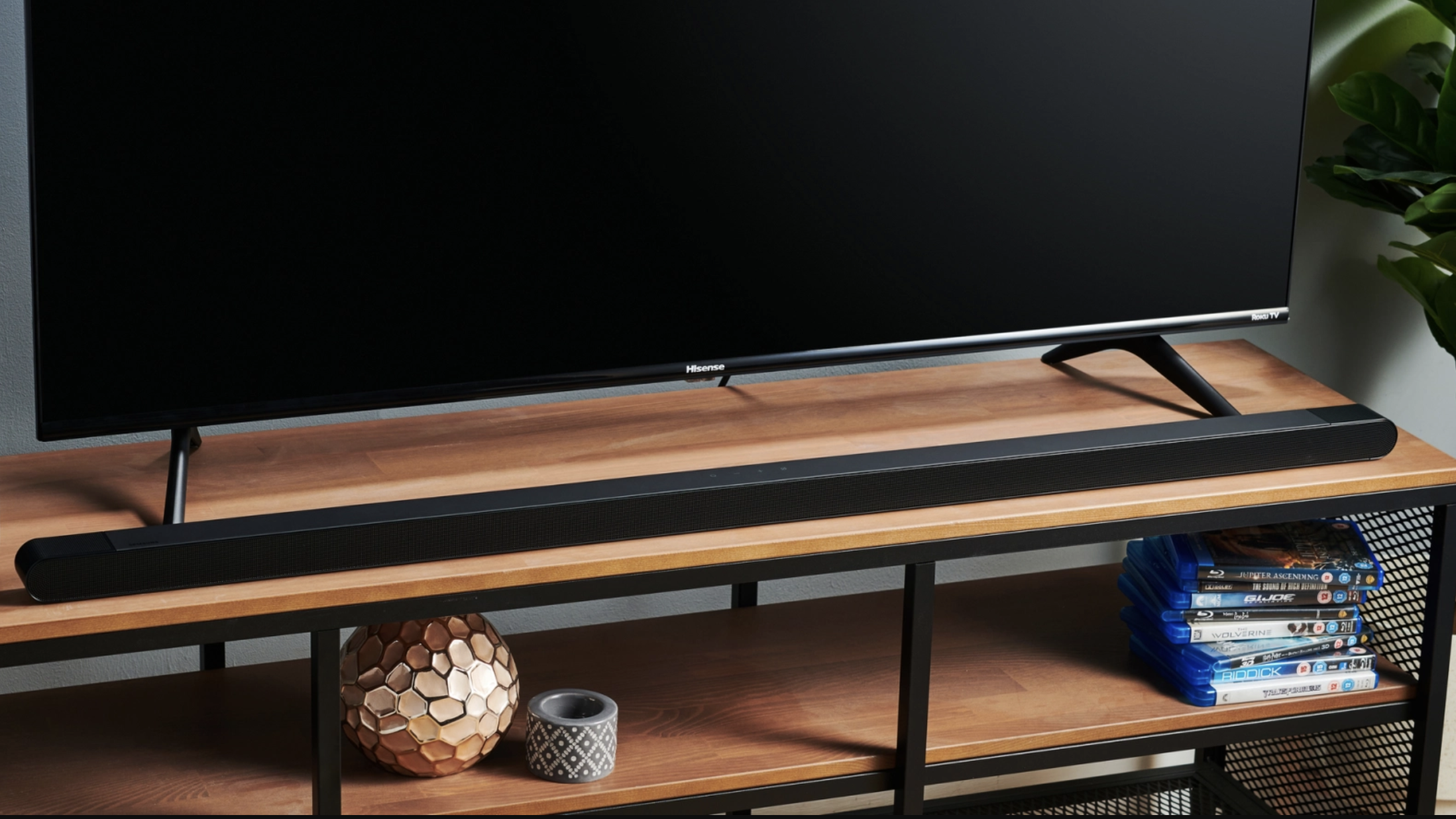 The Samsung HW-S800B soundbar on a wooden surface under a TV