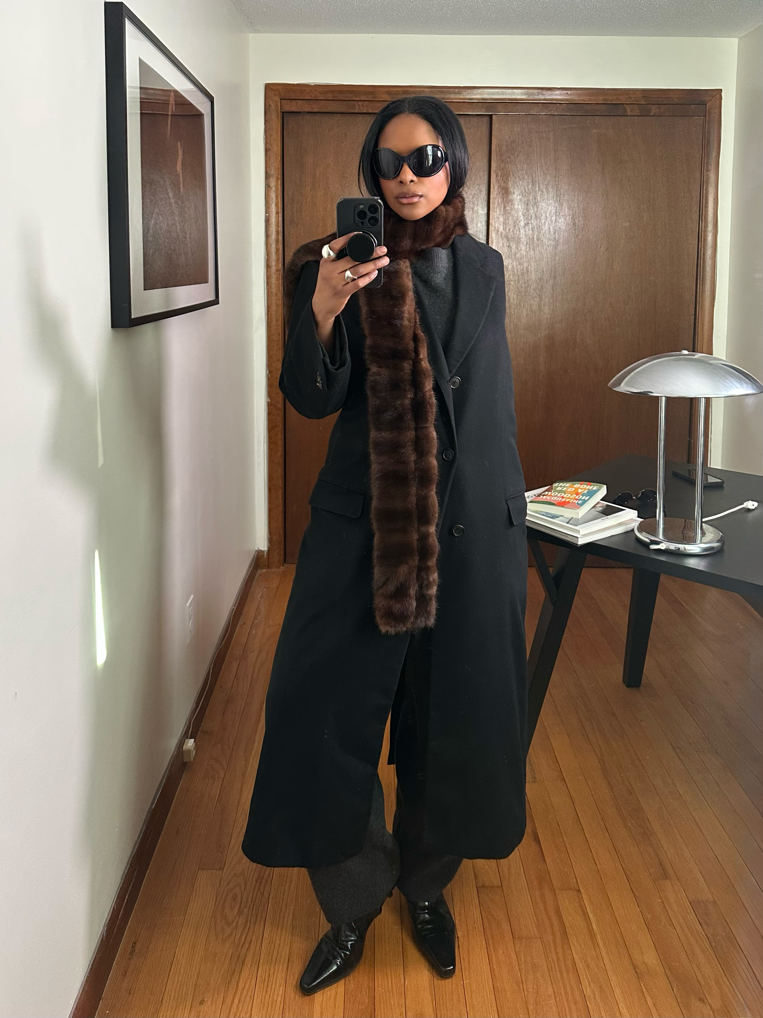 Maya Moore wearing a thick brown scarf over an all black outfit