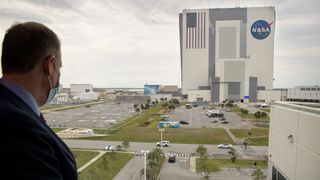 NASA Administrator Jim Bridenstine watches as NASA astronauts Doug Hurley and Bob Behnken return to the Neil A. Armstrong Operations and Checkout Building from Launch Complex 39A after the launch was scrubbed due to weather, on May 27, 2020.