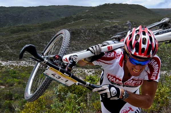 American Paul Romero drags his bike up the course on stage 3.