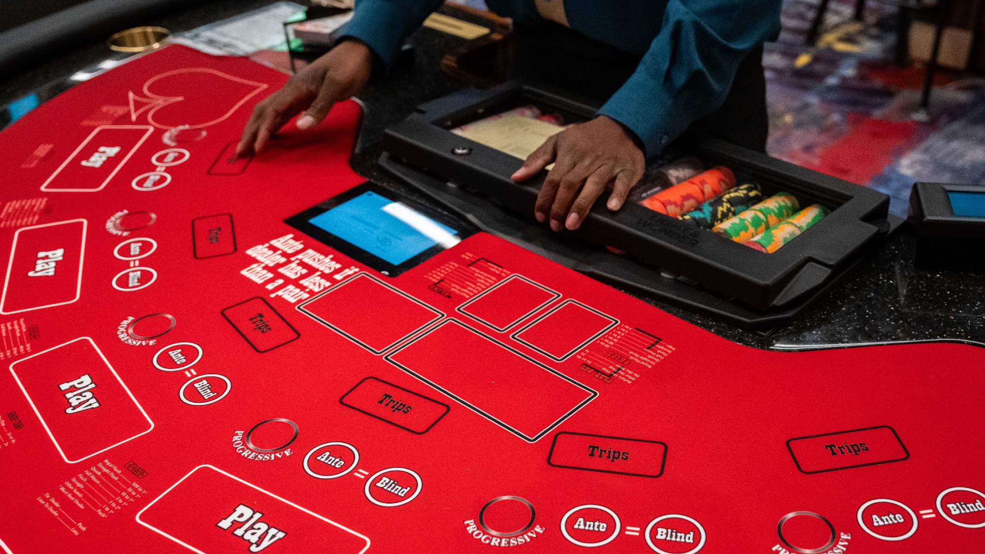 A dealer at a cards table at a Resorts World casino