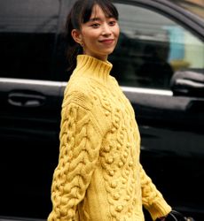 woman wearing yellow sweater on the street