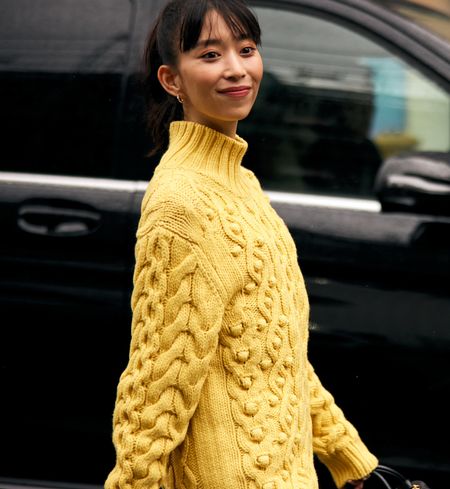 woman wearing yellow sweater on the street