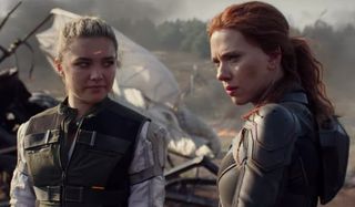 Black Widow Florence Pugh and Scarlett Johansson stand near some wreckage