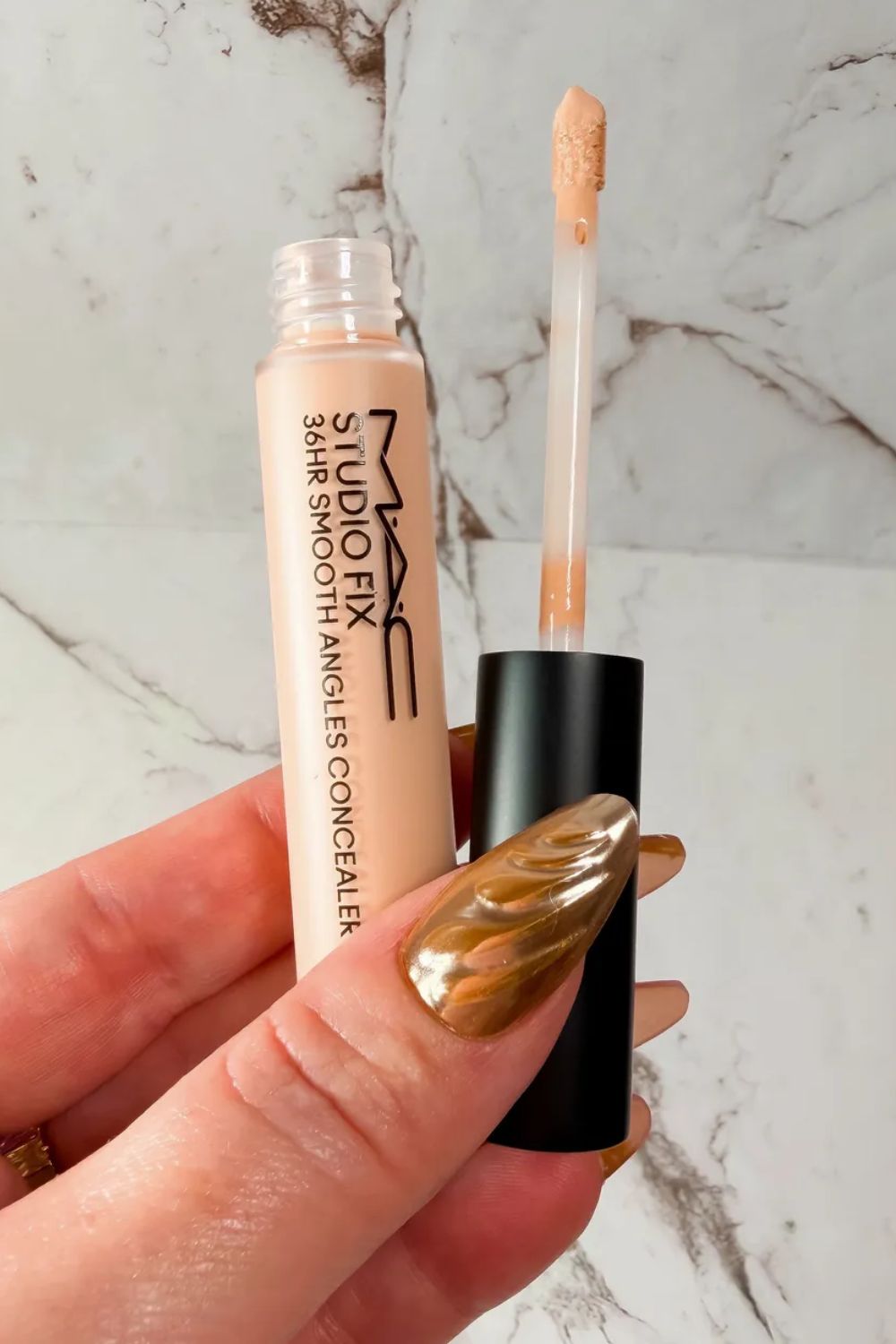 Laura Pearson holding the MAC Studio Fix 36HR Smooth Angles Concealer