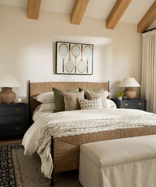 McGee & Co guest bedroom with rattan bed, neutral bedding and racket wall picture