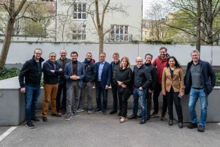 The management team at Celonis posing for the camera outside an office