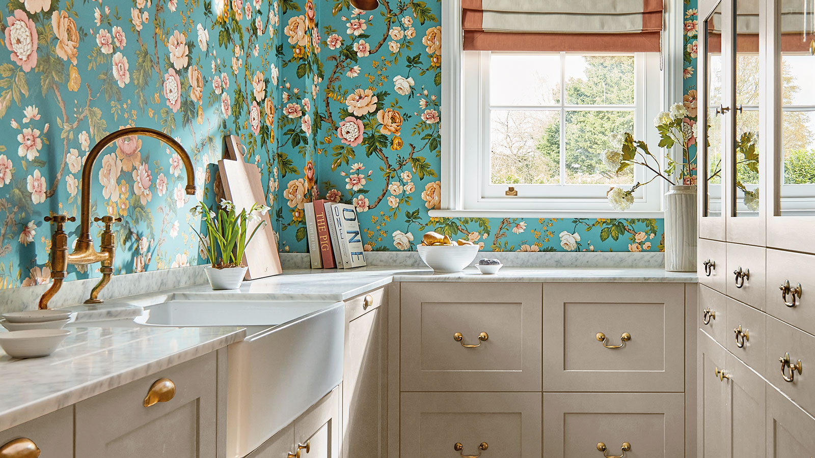 narrow white utility room with blue floral patterned wallpaper