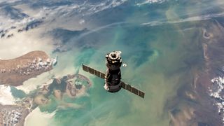 a Soyuz spacecraft floats above the Caspian Sea in Kazakhstan