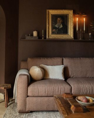 Patterned rust couch in a burgundy living room