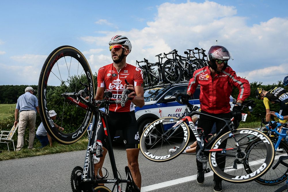 Jelle Vanendert picks up his bicycle after being caught in a massive pack fall in the last kilometers of the fourth stage of the 105th edition of the Tour de France