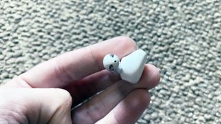 a close up of one of the oppo enco air wireless earbuds