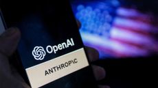 Logos of AI developers Anthropic and OpenAI pictured on a smartphone screen with American flag blurred in background.