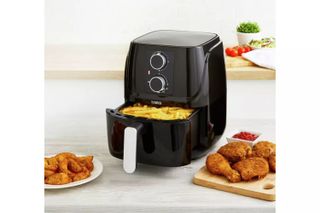 the Tower airfryer on a kitchen sideboard with chips and chicken
