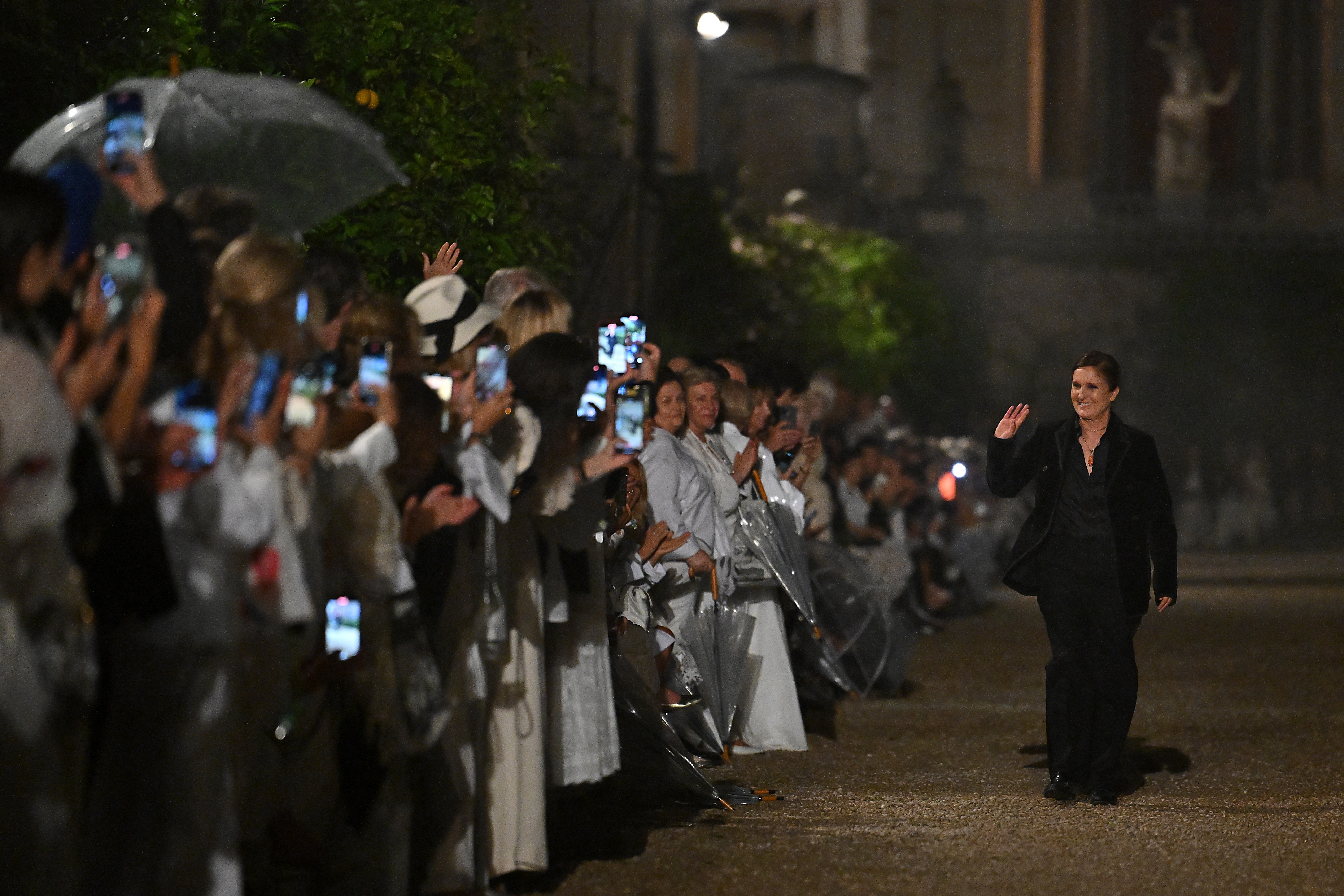 Maria Grazia Chiuri bowing at Dior during her final collection