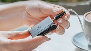 iFi Go Blu Air DAC held in the hand 