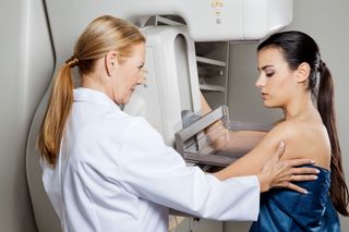 A woman gets a mammogram