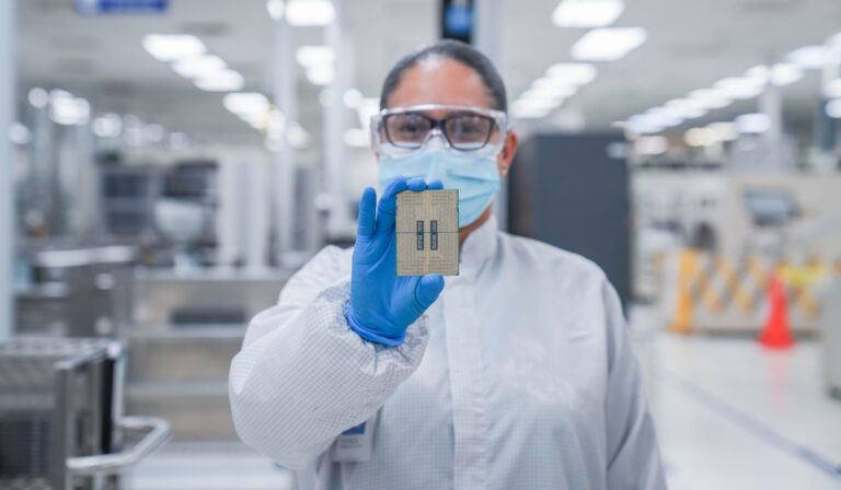 A chip being held up in an Intel fab