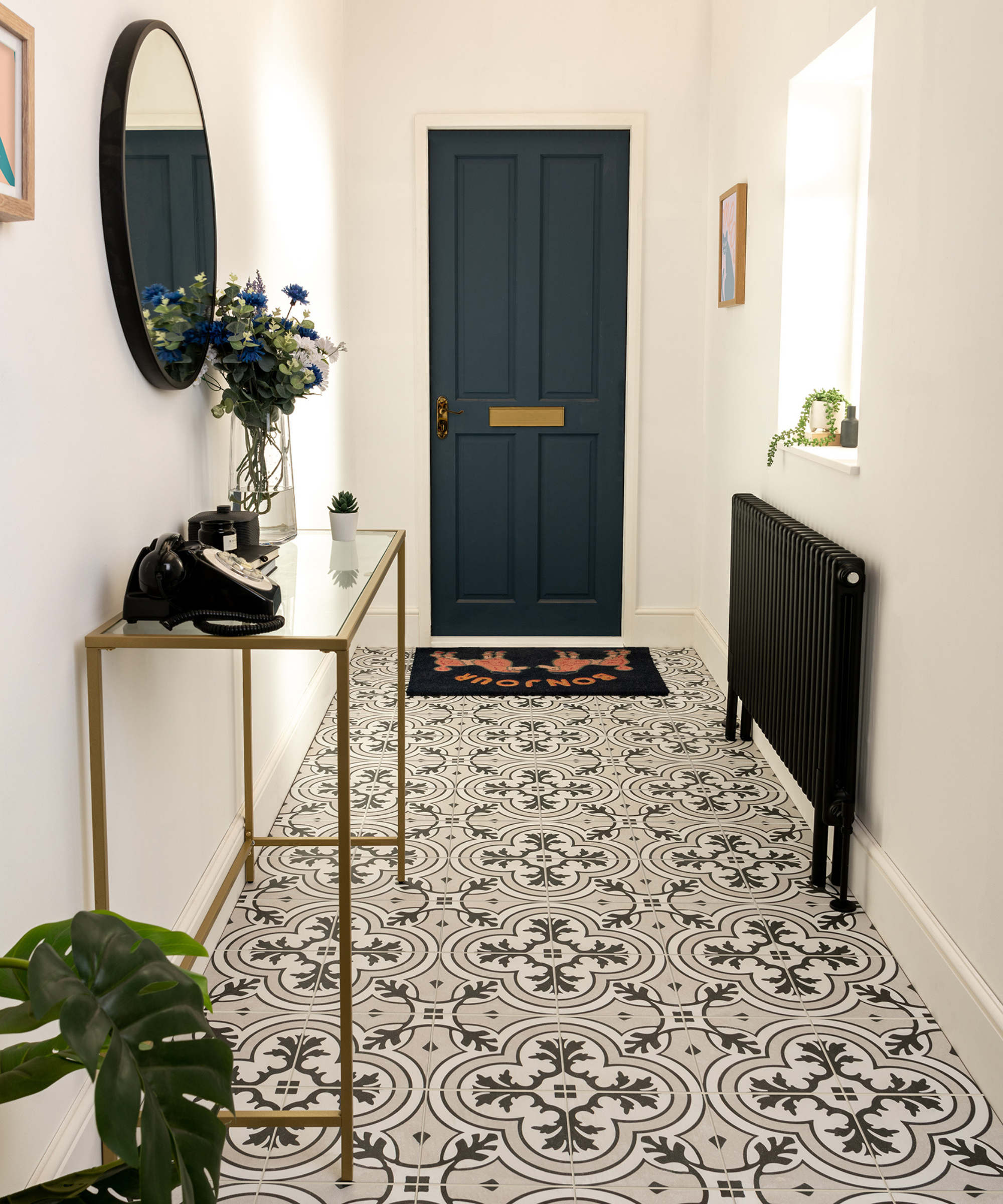 Hallway with patterned black and white tiles