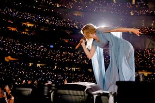 Taylor Swift wears a sky blue alberta ferretti dress with sheer sleeves at the eras tour