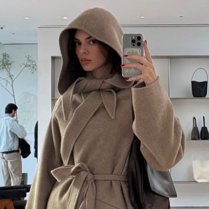 Kendall Jenner in a tan scarf coat by The Row in a picture she shared on her Instagram Story.