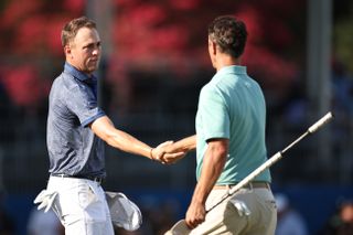 Justin Thomas and Adam Scott shake hands on the 18th green