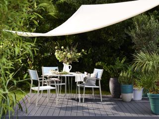 outdoor dining area under a shade sail