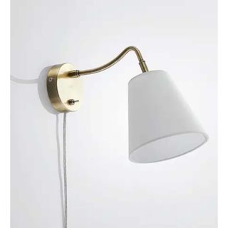 white and brass wall light with cable
