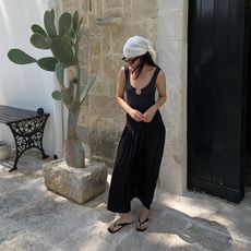 johanna wears black dress, white scarf, and black thong sandals 