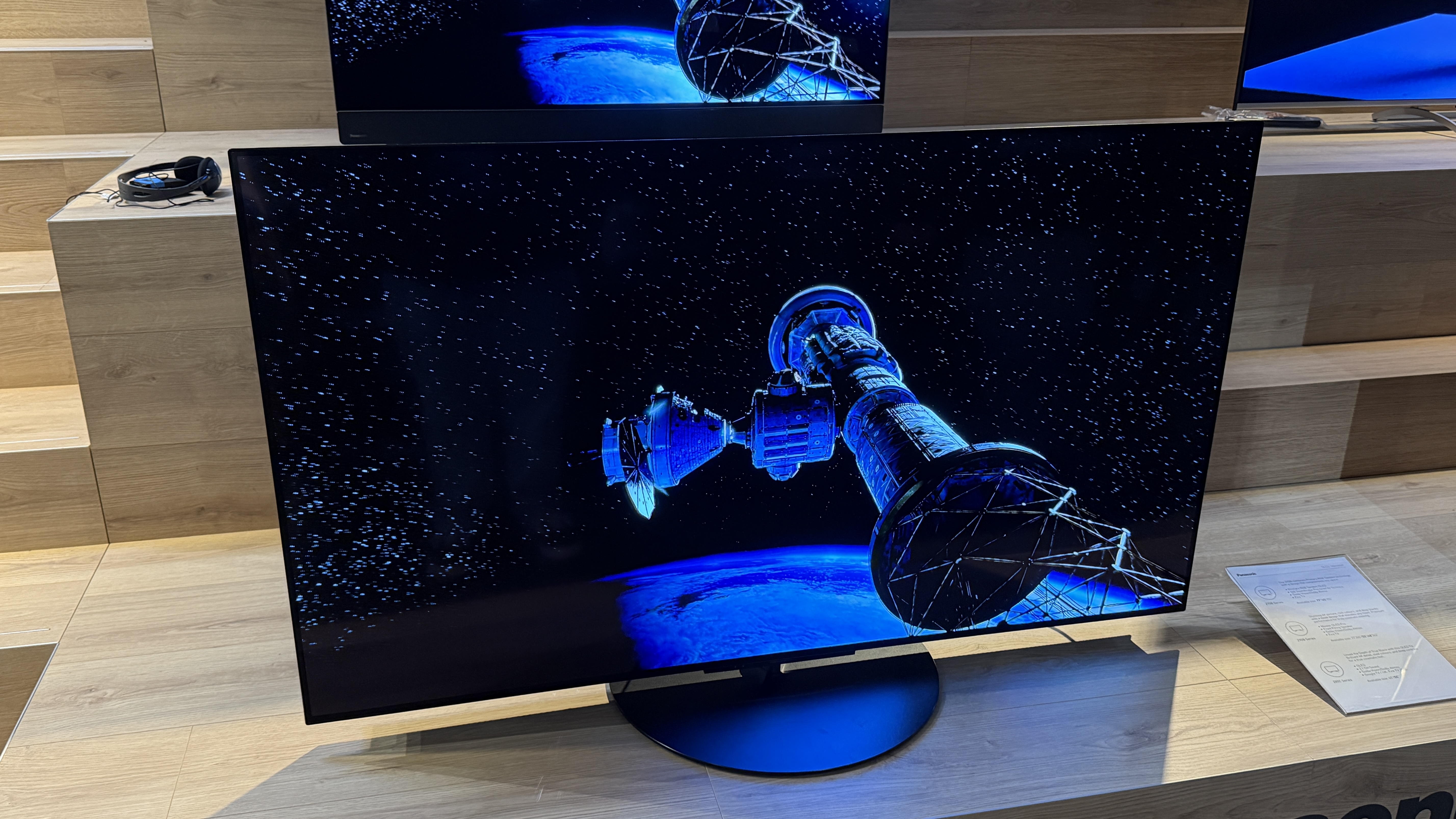 Panasonic Z85C with sci-fi images on screen sitting on a wooden tabletop