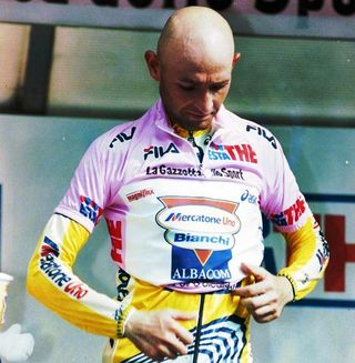 Marco Pantani pulls on the maglia rosa for the last time in his career after winning the 1999 stage to Madonna di Campiglio