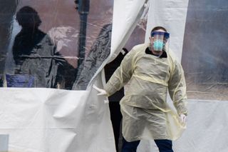 A health care worker walks out of a COVID-19 testing site in Dayton, Ohio.