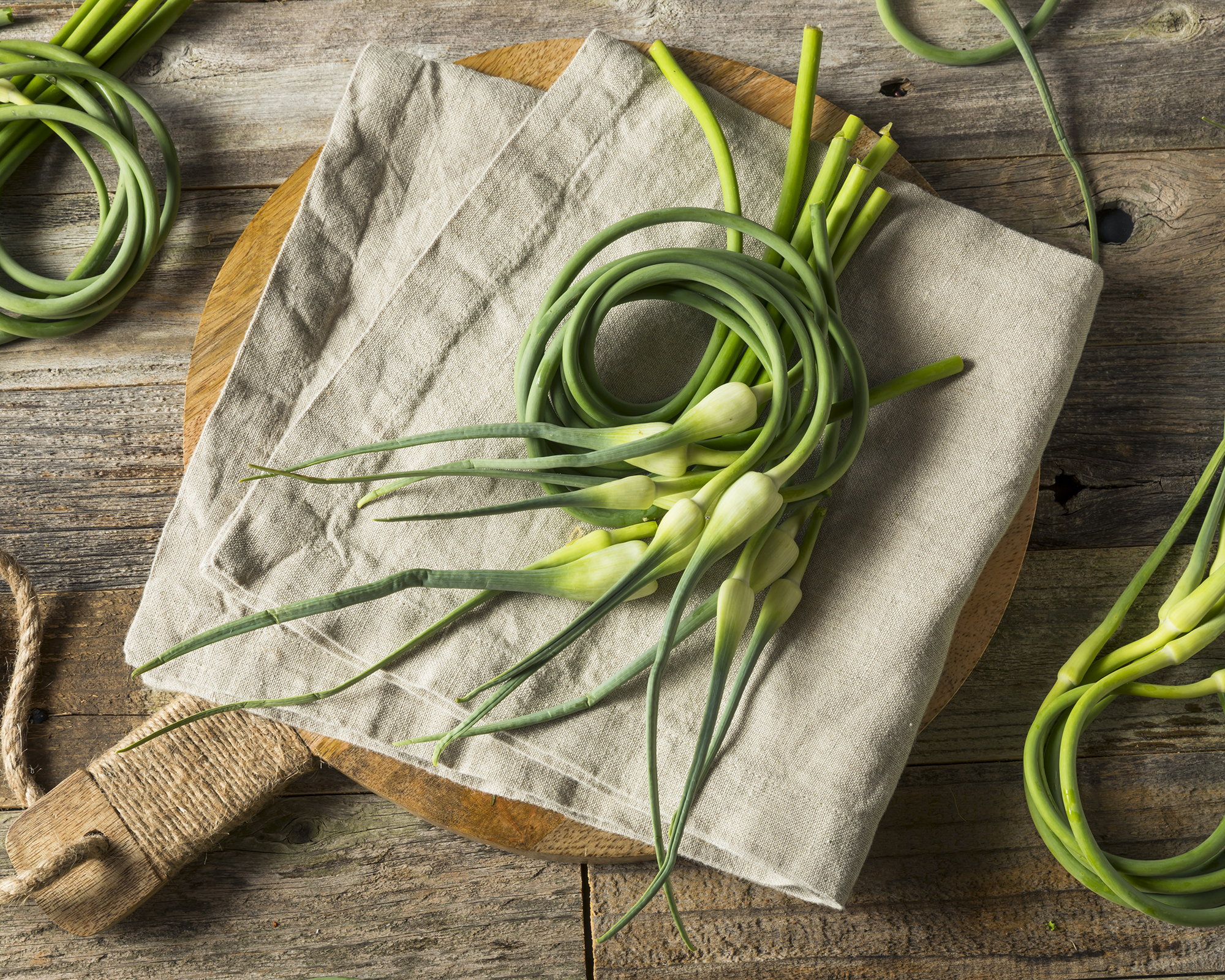 Garlic scapes on cutting board in kitchen