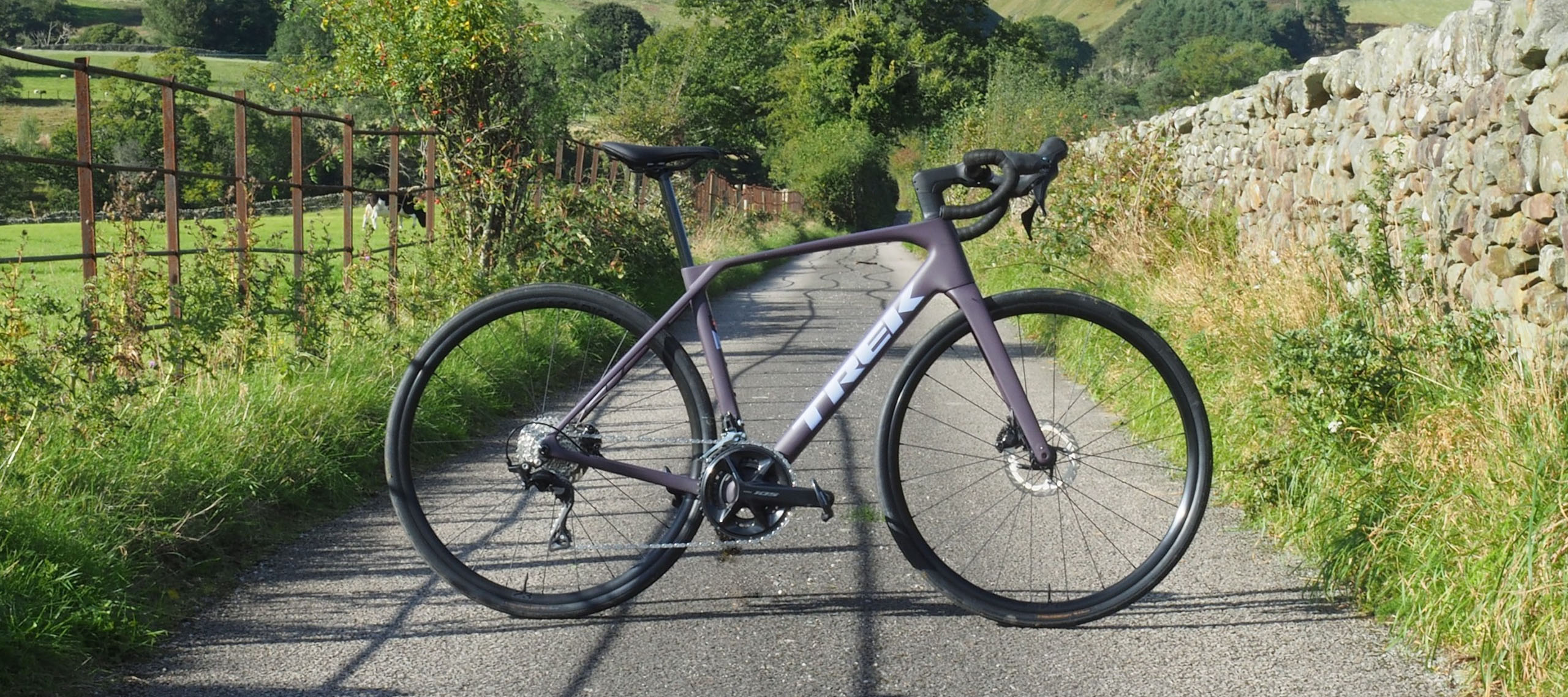 A Trek Domane SL 5 Gen 5 seen from the side on a country lane