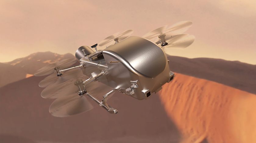 illustration of a silvery metallic rotorcraft flying over orangish dunes