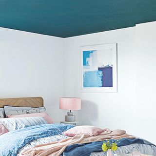 small bedroom with blue ceiling