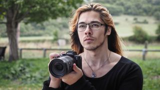 Our reviewer, James, holding the Sony A7 III.