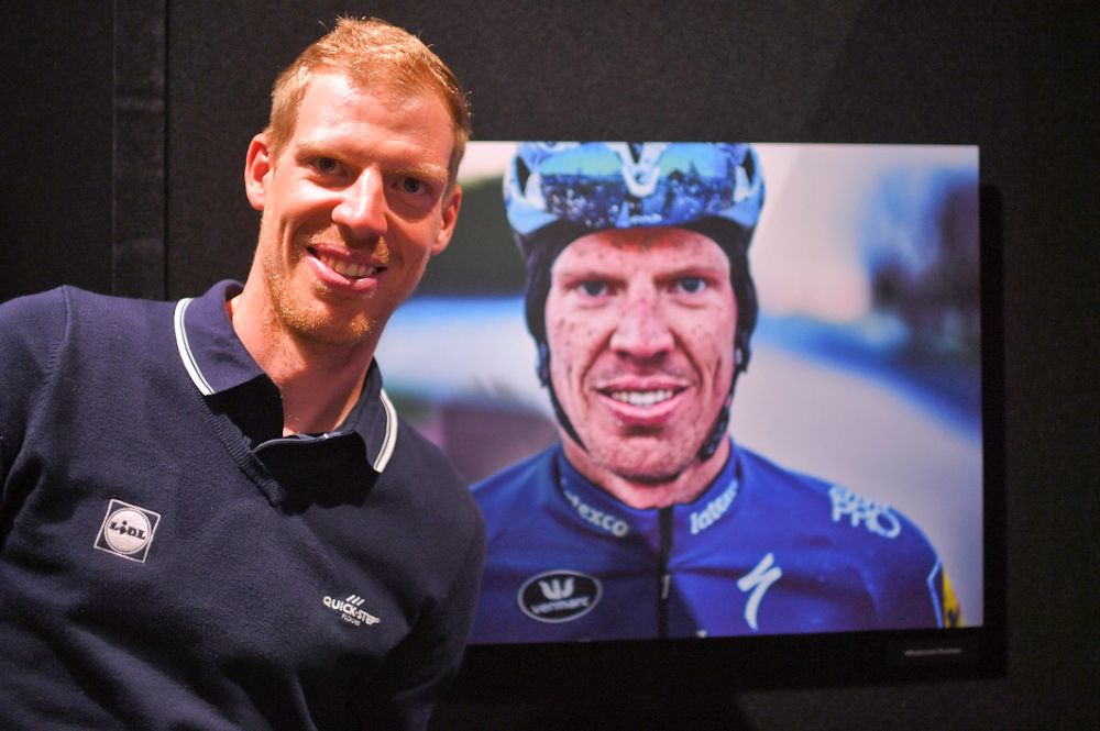 Tim Declercq in front of a photo of himself at the Deceuninck-QuickStep presentation