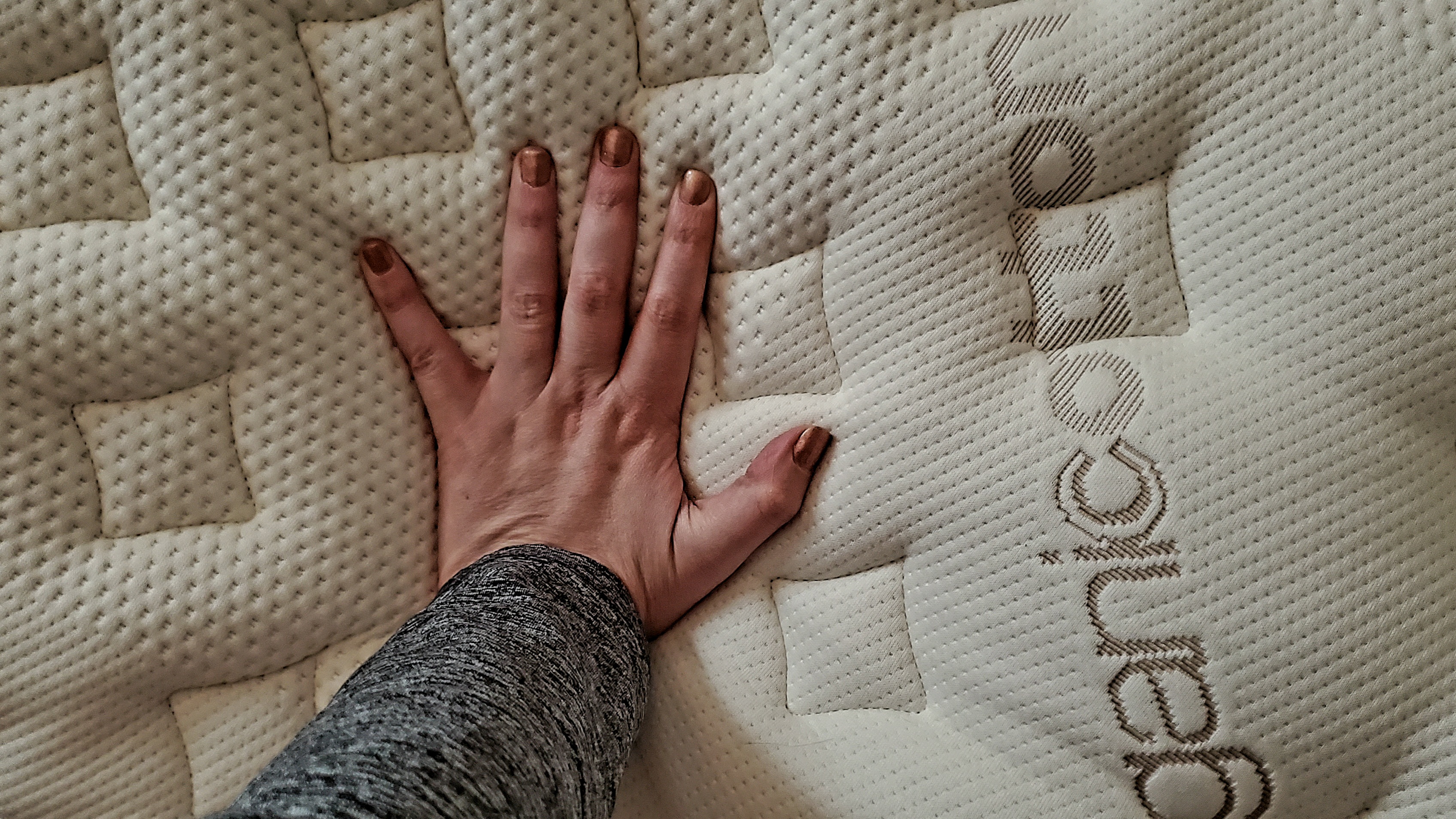 Loom & Leaf mattress review hand on mattress