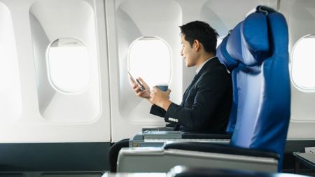 A man sitting on a plane waiting for take off. 