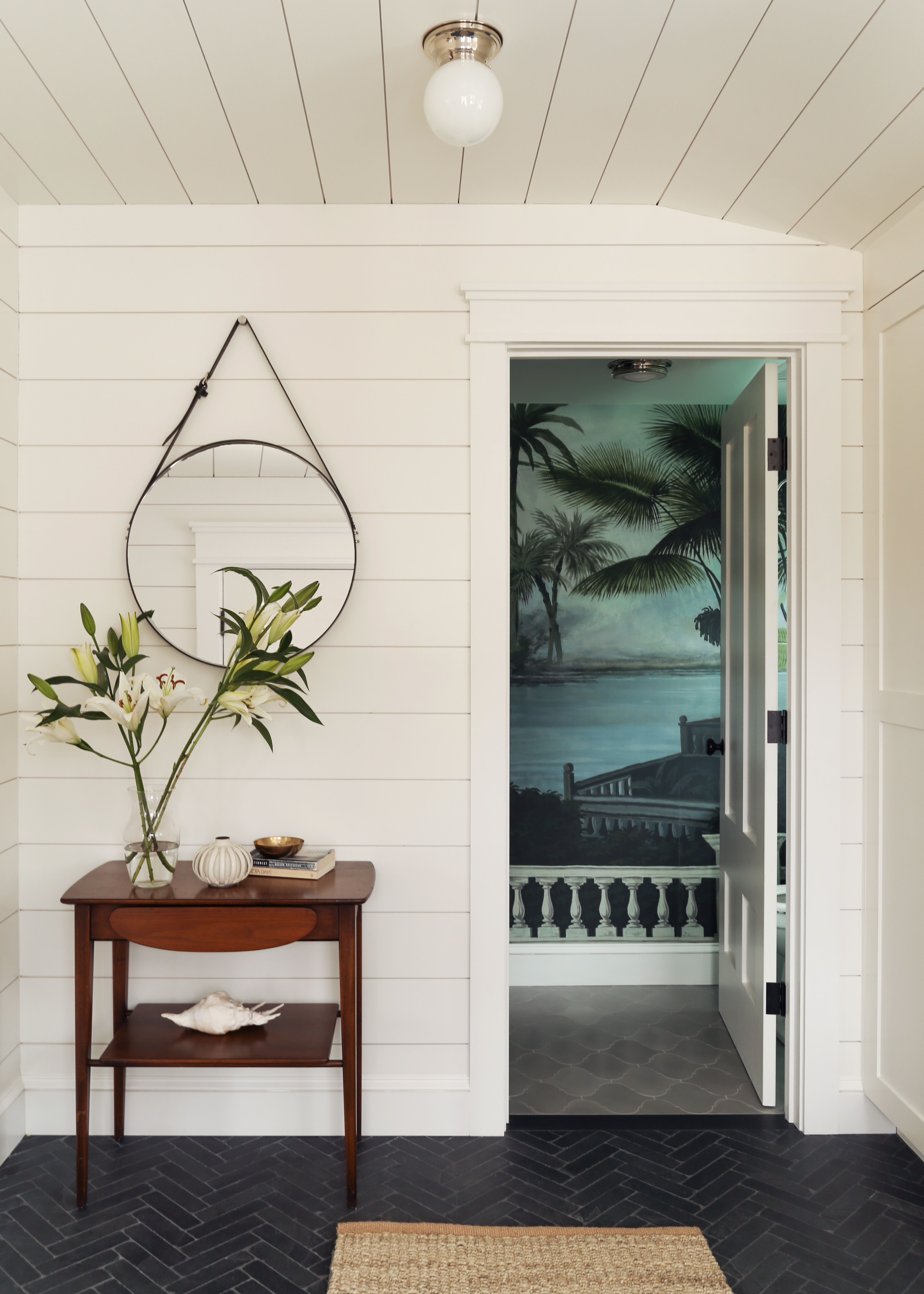 Side table with circular mirror above