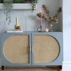 Blue Ikea sideboard hack with rattan lining.