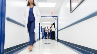 A doctor walking down a hallway.