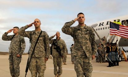 Troops salute after they arrive at their home base of Fort Hood, after being part of one of the last American combat units to exit from Iraq on December 16, 2011.