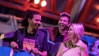 Three riders smiling in a shuttle on Guardians of the Galaxy: Cosmic Rewind.